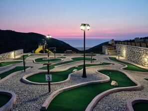 Play a round of golf amidst scenic ocean views and winding paths.
