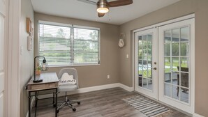 A room with a ceiling fan, a desk with a lamp, a chair, and a window with blinds. - ⭐️POOL|GAMEROOM*Lanai Hangout*Open Concept Design🌊 (Ocala)