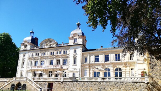 A large, historic building with two prominent domes, a stone wall, and a grassy courtyard. - Apartment “Bagnols” in Theizé with sauna (Theizé)