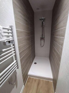 Shower, hair dryer, towels, toilet paper