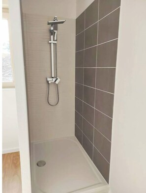 Shower, hair dryer, towels, toilet paper