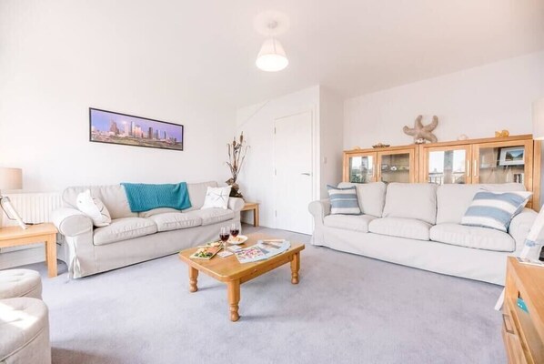 A living room with two sofas, a coffee table, and a cabinet. - Rest Ashored, Aldeburgh (Aldeburgh)