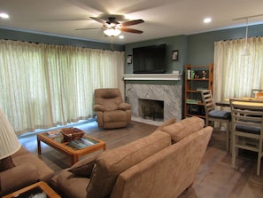 Cozy living space with a fireplace, television, and comfortable seating area.