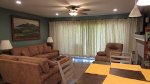 A living room with a sofa, armchair, dining table, and ceiling fan. - Reconfigured 2 bedroom, 2 bath condo, walking distance Pinehurst Resort. (Pinehurst)