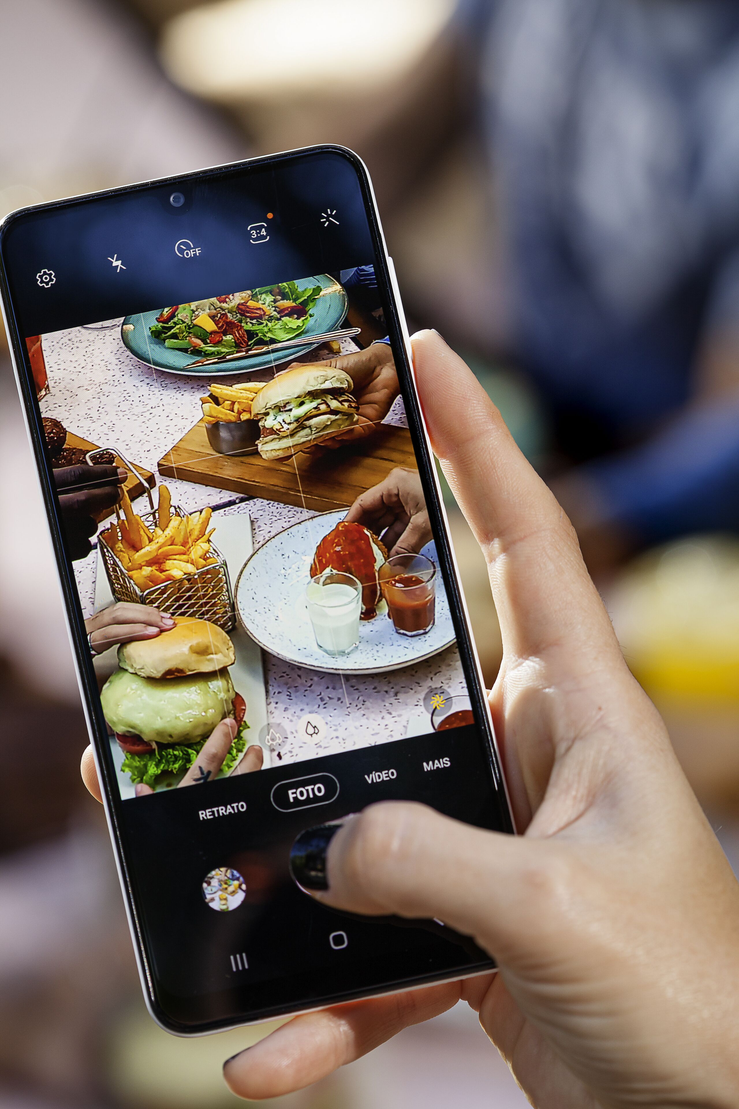 A smartphone displaying a food menu with various dishes and drinks.