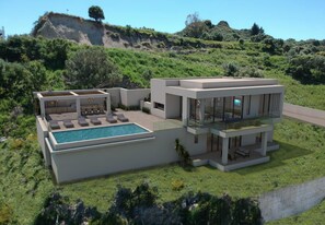 A modern two-story house with a swimming pool, outdoor seating, and a view of a hillside.