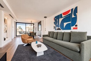 A modern living room with a sofa, armchair, and coffee table.
