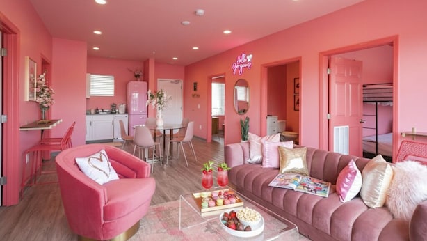 A pink-themed living room with a sofa, armchair, and coffee table. - 🍷🌇  All Day & Night!  BEST EAST NASH location - Walkable (Nashville)