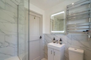 Combined shower/bathtub, towels, soap, toilet paper
