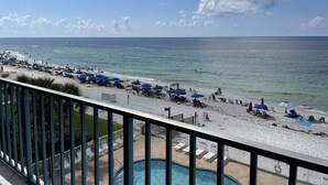 A beach with umbrellas, lounge chairs, and a pool. - Surf Side Shores 2405  2 bd 2 ba  gulf-front  (Gulf Shores)