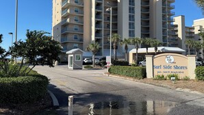 A multi-story hotel with balconies, a sign reading 'Surf Side Shores,' and a clear sky. - Surf Side Shores 2405  2 bd 2 ba  gulf-front  (Gulf Shores)