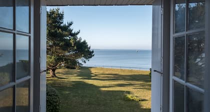 Family home with the ocean at the end of the garden.