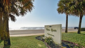 A sign for Ocean Grove with a view of the beach and palm trees. - Pelican View by Ryson Vacation Rentals (Galveston)