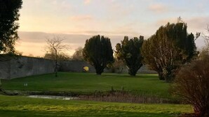 A grassy field with trees and a stone wall. - 2 Bed Suite With Tea/coffee Making Facilities (Kells)