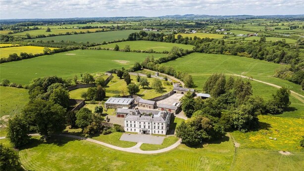 An aerial view of a large estate with a central building surrounded by expansive green fields and a few scattered trees. - 2 Bed Suite With Tea/coffee Making Facilities (Kells)