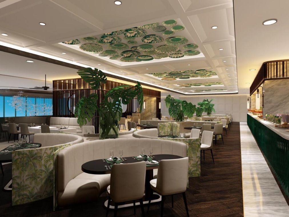 A modern hotel lobby with seating areas, a bar, and a large screen.