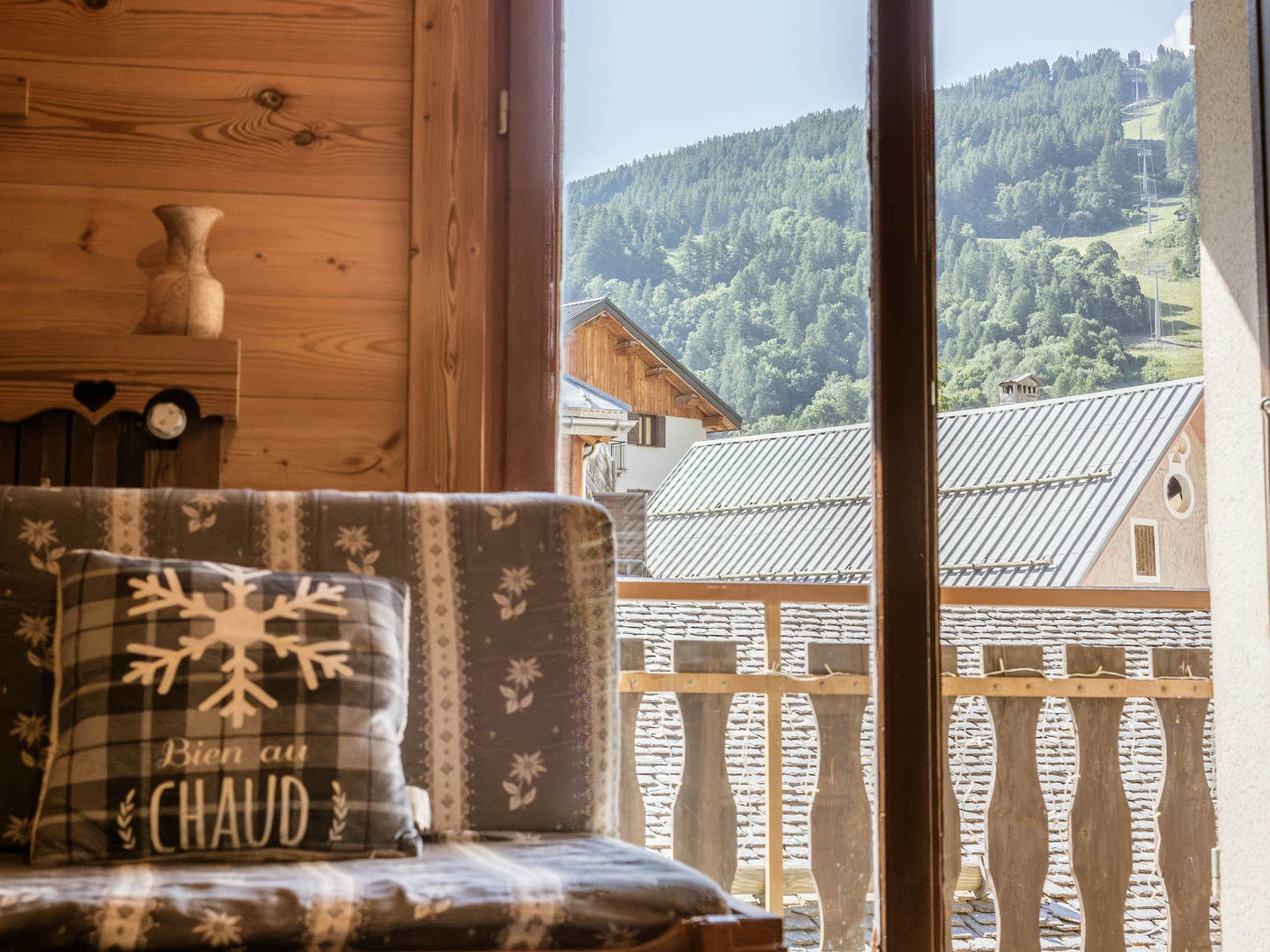 A wooden interior with a view of a mountainous landscape.