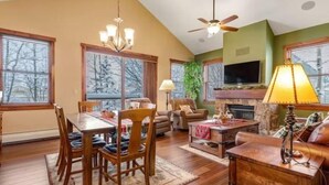A spacious living room with a dining area, a fireplace, and a television. - 3 Bedroom Townhome in Downtown Breckenridge, off Main Street With Pool, and Hot Tubs (Breckenridge)