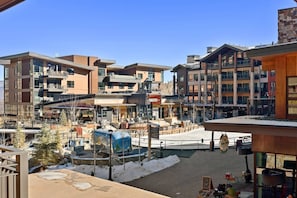 A multi-story hotel with a central courtyard, outdoor seating, and a view of the surrounding buildings.