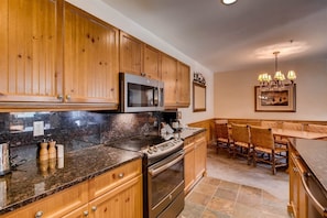Enjoy cooking in the well-appointed kitchen with stainless steel appliances and a dining area for meals.