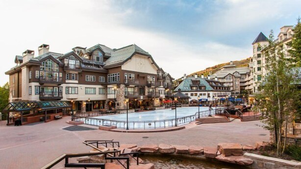 A large building with multiple floors, a central courtyard with a fountain, and surrounding shops. - Chic Ski In, Ski Out 2 Bedroom Penthouse in Beaver Creek Village (Avon)