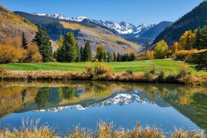 Escape to a serene lakeside retreat with a peaceful gazebo and breathtaking mountain views.