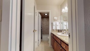 A narrow bathroom with a sink, mirror, and towel rack. - 4 Bedroom Condo in Lionshead at Boutique Resort Within Walking Distance to the Eagle Bahn Gondola (Vail)