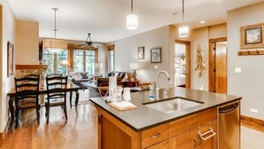 A spacious kitchen with a large island, wooden cabinetry, and a built-in dishwasher. - Luxury 2 Bedroom Mountain Vacation Residence With Hot Tub, Pool, and Easy Access to Ski Slopes (Breckenridge)