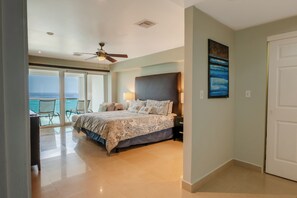 A bedroom with a bed, a nightstand, a lamp, and a painting on the wall.