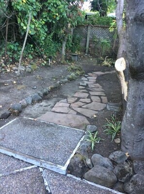 Stroll through the serene garden to a charming entrance.