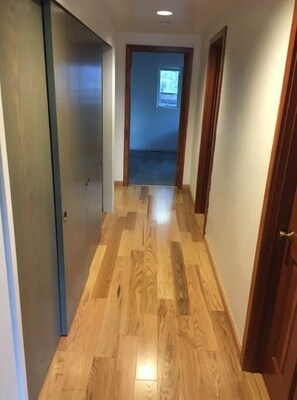 Stylish hallway leading to a room with a window.