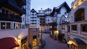 A narrow street lined with multi-story buildings featuring balconies and large windows, suggesting a historic or boutique hotel setting. - 1 Bedroom Boutique Resort Condo With Hot Tub Access and Within Walking Distance to the Eagle Bahn Gondola (Vail)