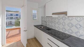 Fridge, coffee/tea maker, highchair, cookware/dishes/utensils