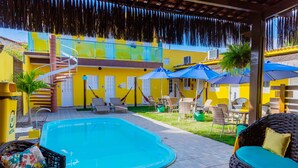 A pool area with a blue pool, wicker furniture, and umbrellas. - POUSADA SUMMER BEACH BY AFT (Ipojuca)