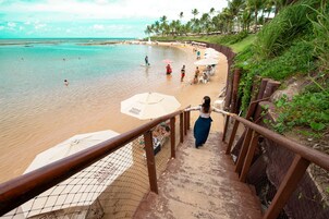 On the beach, white sand, sun loungers, beach umbrellas