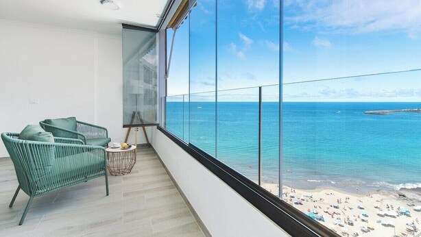 A balcony with a view of the ocean and beach. - Home2Book Blue Sea View Patalavaca Beach Apartment (Patalavaca)