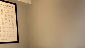 A laundry area with two white washing machines and a wall-mounted laundry guide. - The Ingrid - Entire 2 Bedroom Apt in Quilt Town, USA (Hamilton)