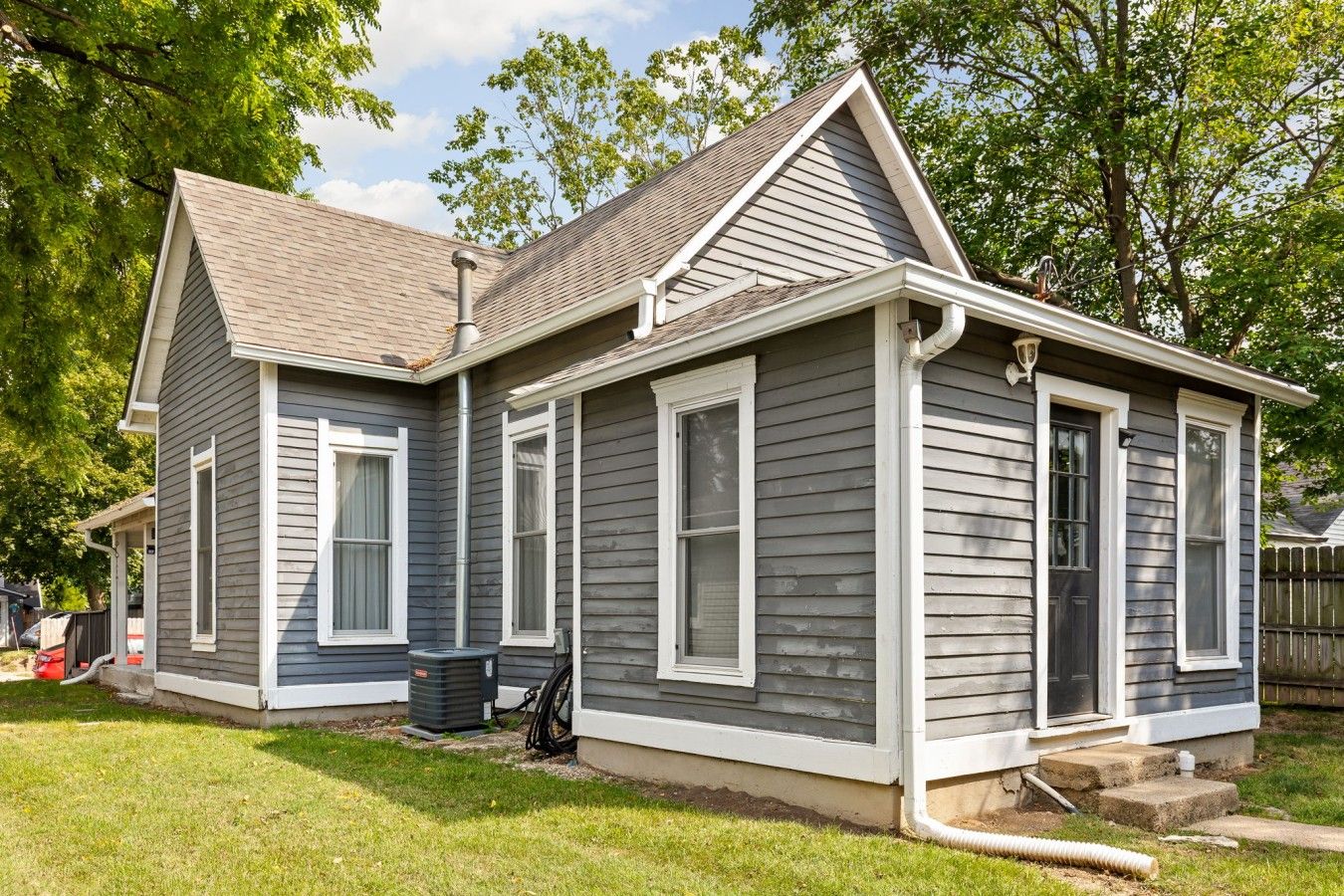 A two-story house with a front porch, a chimney, and a garage.
