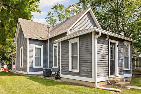 A two-story house with a front porch, a chimney, and a garage.