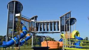 A playground with slides and climbing structures.