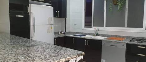 Fridge, dishwasher, coffee/tea maker, cookware/dishes/utensils