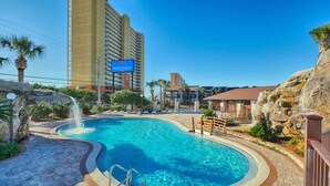 A hotel with a large pool, a sign reading "PORTSIDE", and a tall building in the background. - Portside townhouse with beach access and pools (Panama City Beach)