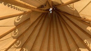 A tent-like structure with a wooden frame and a patterned fabric canopy. - Grand Canyon Glamping Resort (Meadview)