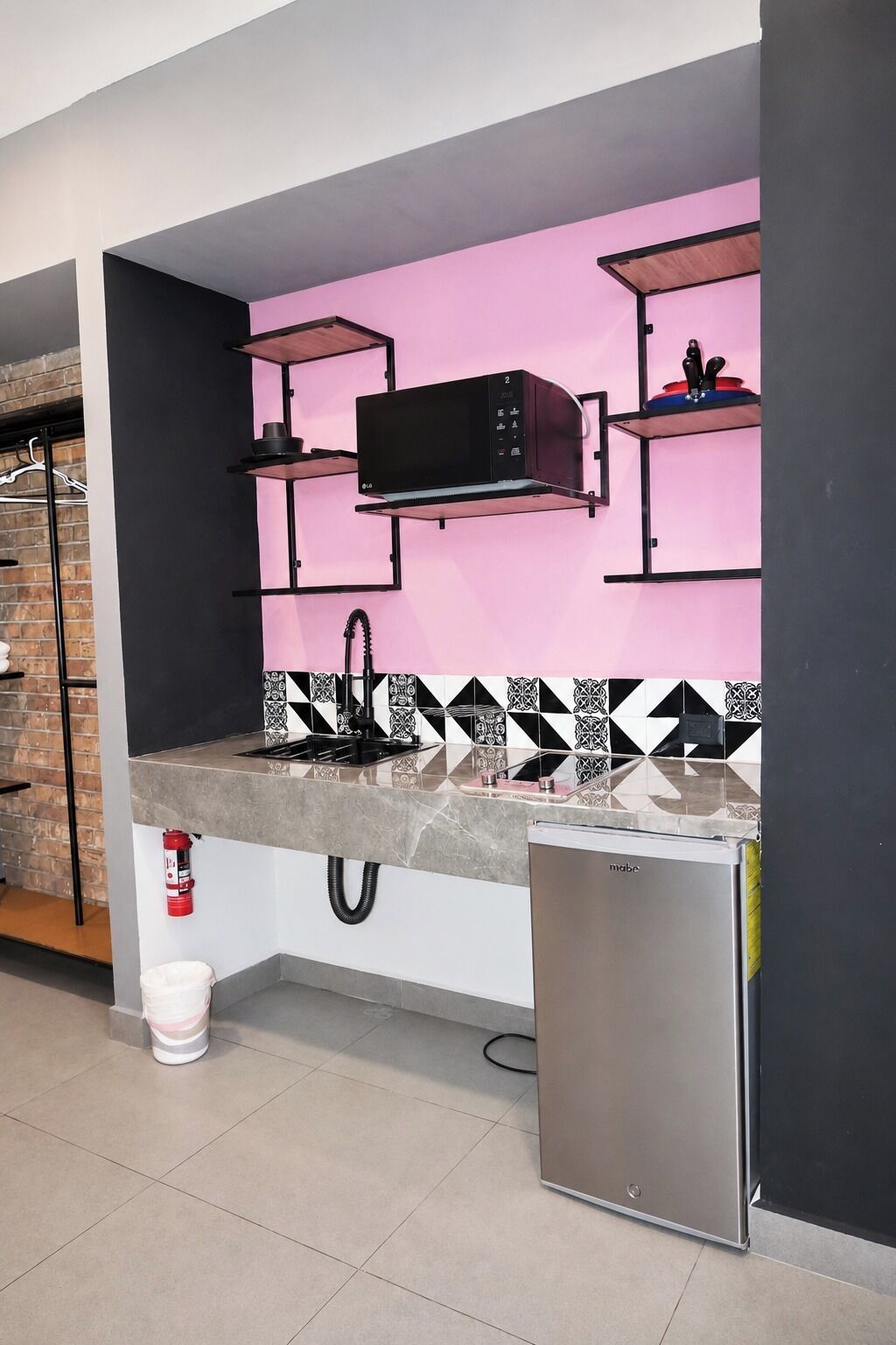 A compact kitchen with a microwave, a sink, and a refrigerator.