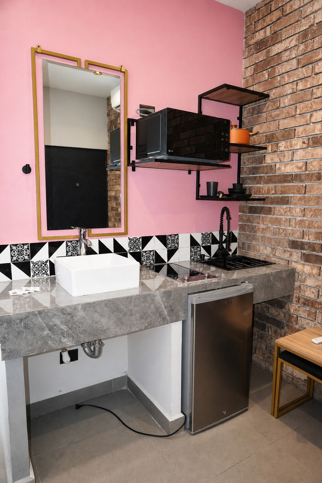 A compact kitchen with a built-in microwave, a sink, and a dishwasher.