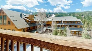 A multi-story lodge with a wooden exterior, multiple balconies, and a view of a forested valley. - 1 Bedroom Mountain Condo in River Run Village With Expansive Mountain Views and Walking Distance to Ski Slopes (Keystone)