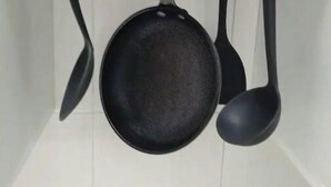 A kitchen with hanging utensils including a pan, a ladle, and a spatula. - Pretty Kigali studio. (Kigali)