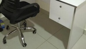 A white desk with a black office chair, a black speaker, and a small drawer. - Kigali gorgeous Studio (Kigali)