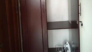 A wardrobe with a closed door and a hanging iron inside. - Kigali gorgeous Studio (Kigali)
