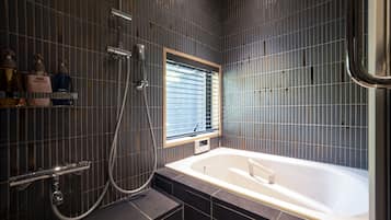 Standard Suite | Bathroom | Separate tub and shower, free toiletries, hair dryer, slippers